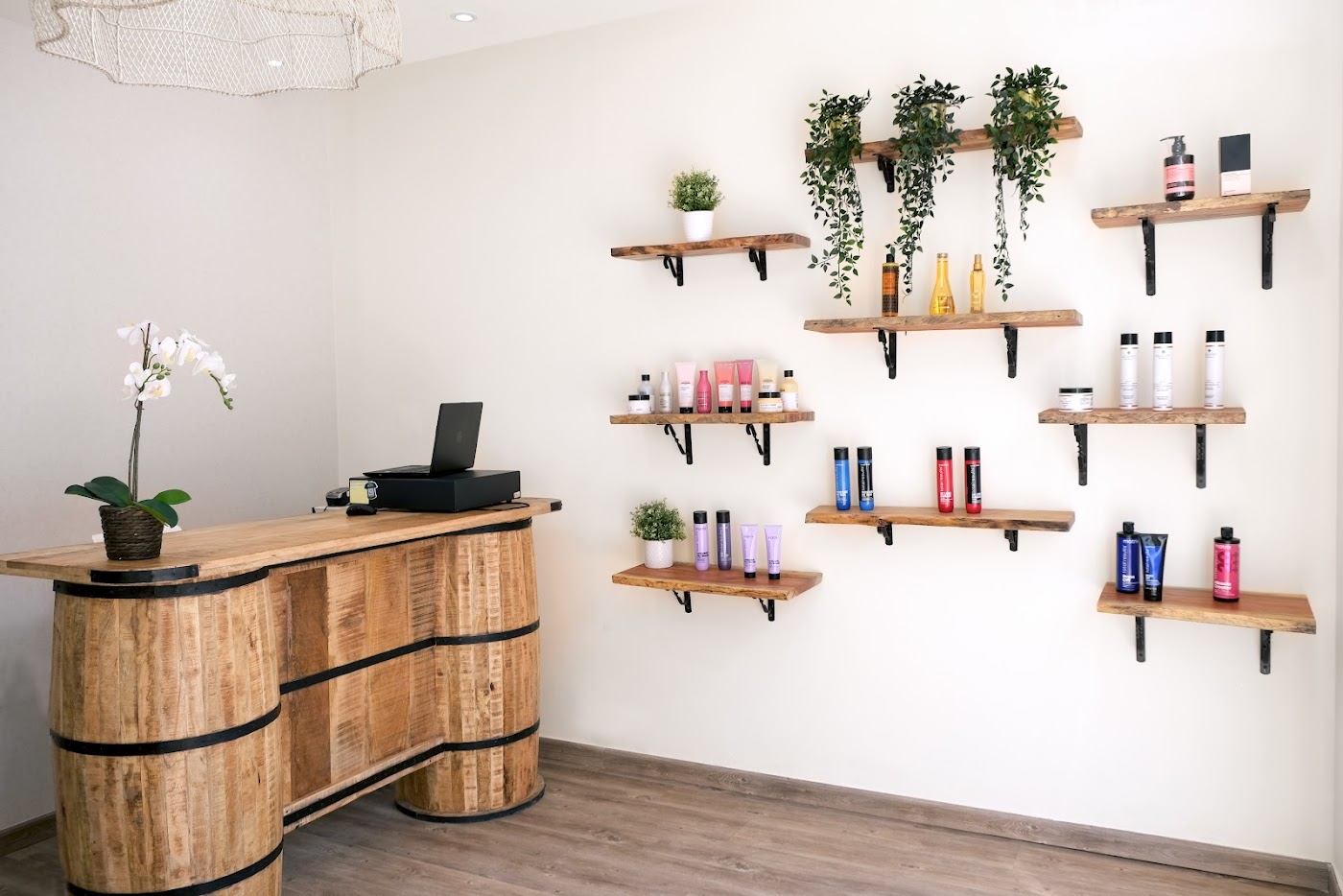 Reception at Sky Beauty Salon with wooden counter and floating shelves