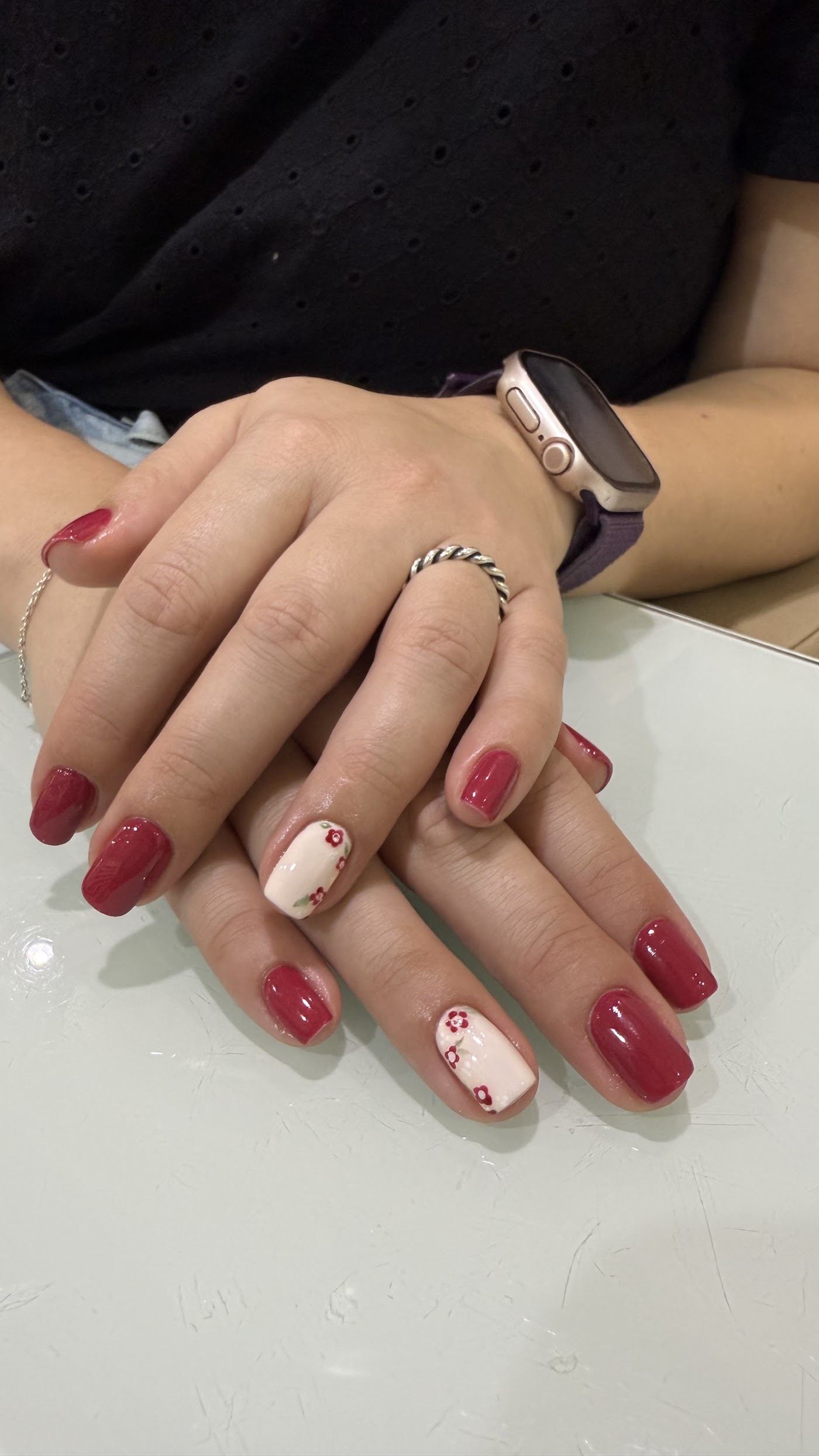 Red manicure with a heart accent nail